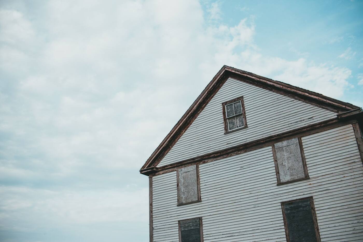 Before: worn siding and an aging roof